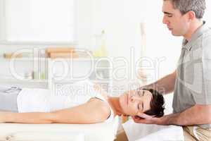Chiropractor stretching a charming woman