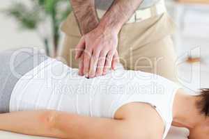 Masseur massages customer's back