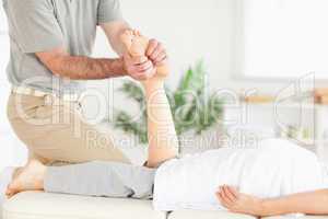 Masseur massaging a customer's foot