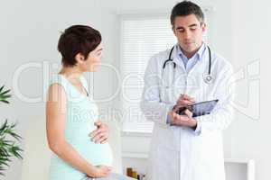 Pregnant woman talking to her doctor