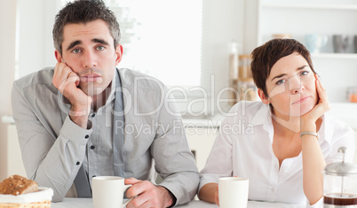 Worn out couple drinking coffee