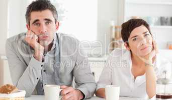 Worn out couple drinking coffee