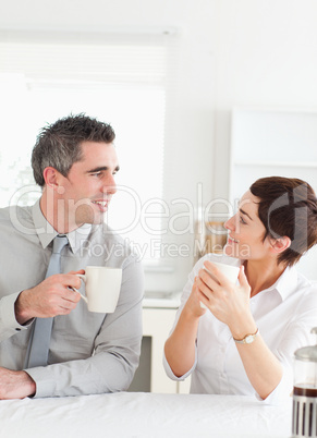 Smiling couple drinking coffee