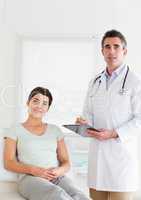 Male Doctor and female patient looking into a camera