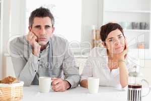 Tired couple drinking coffee