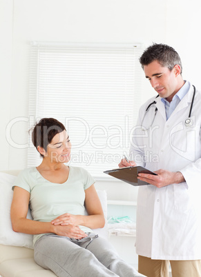 Cute Woman lying down talking to a doctor