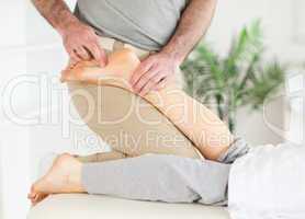 Masseur massaging a female customer's foot