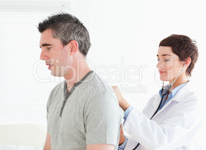 Female doctor examining a male patient