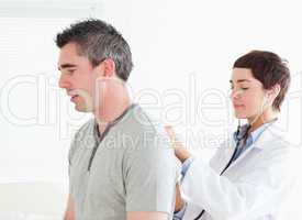Female doctor examining a male patient