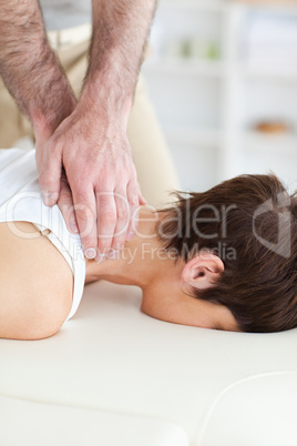 Female customer's neck massaged by masseur