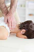 Female customer's neck massaged by masseur