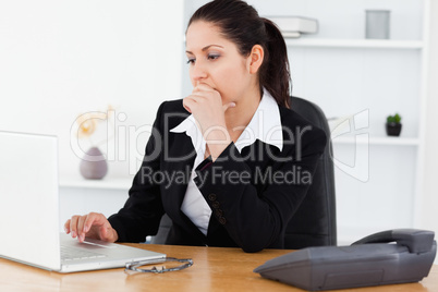 Serious young businesswoman in office