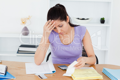 Frustrated young woman accounting