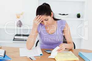 Frustrated young woman accounting