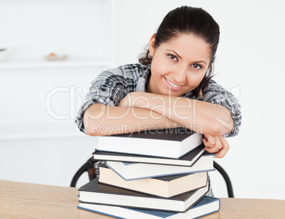 Young student leaning on books