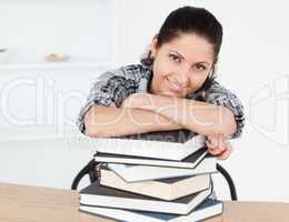 Young student leaning on books