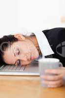 Sleeping businesswoman with her head on laptop