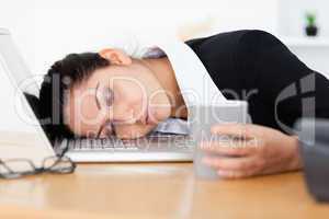 Exhausted businesswoman sleeping at workplace