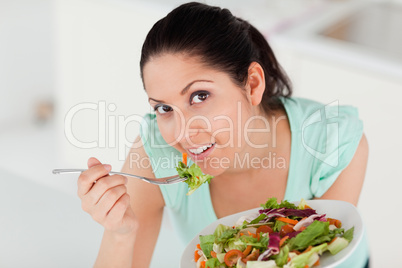 Beautiful woman eating salad