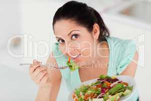 Beautiful woman eating salad
