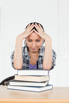 Depressed young  student resting on books