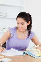 Focused young woman accounting