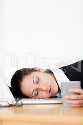 Beautiful businesswoman sleeping in office