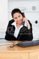 Smiling businesswoman telephoning