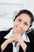 Smiling operator with headset in her office