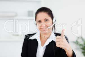 Beautiful businesswoman with thumb up