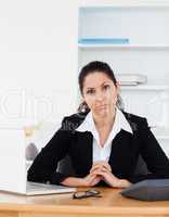 Confident businesswoman sitting in her office
