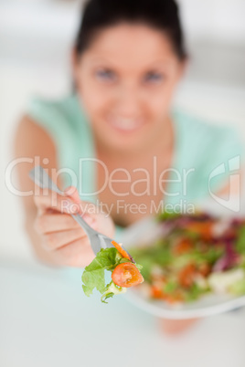 Young woman offering salad