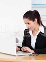 Young businesswoman with laptop in office