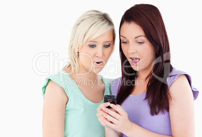 Amazed young women with a cellphone