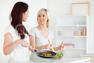 Smiling Women cooking dinner