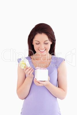 Joyful woman opening a box