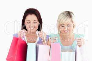 Happy young women with shopping bags