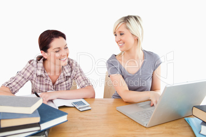 Lovely women learning with laptop and books