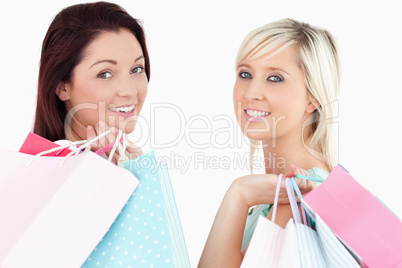 Cheering women with shopping bags