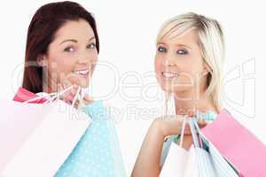 Cheering women with shopping bags