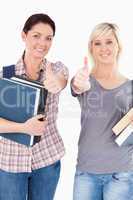 Students with books and thumbs up