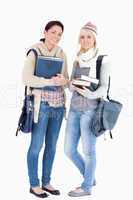 Two students with books prepared for winter