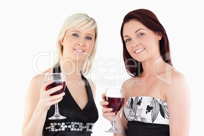 Charming well-dressed women drinking red wine