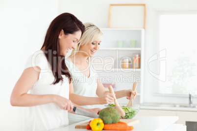 Joyful young Women preparing dinner