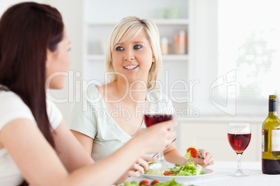 Portrait of beautiful Women eating salad and drinking wine