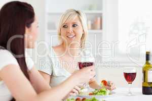 Portrait of beautiful Women eating salad and drinking wine