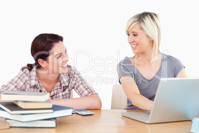 Women learning with laptop and books