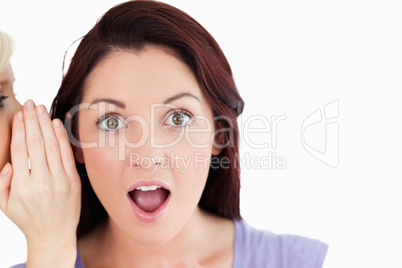 Portrait of a shocked women being told a secret