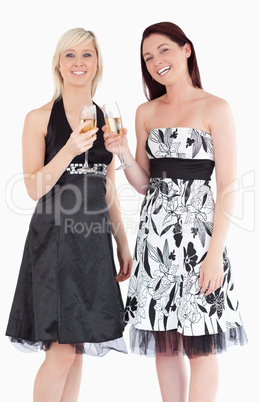 Young women in beautiful dresses with champaign