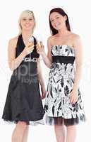 Young women in beautiful dresses with champaign